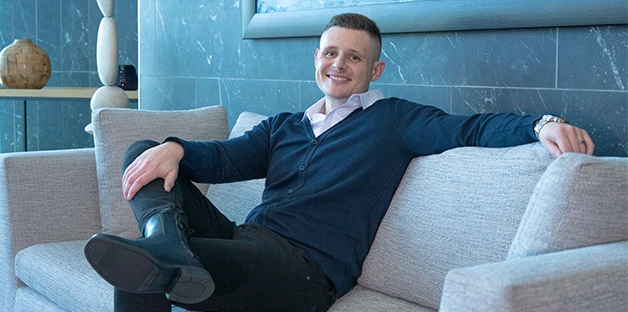 Justin relaxing on a sofa in a comfortable setting