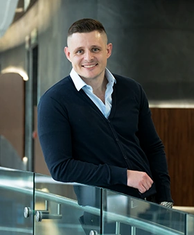 Justin Vorster standing in a modern office setting
